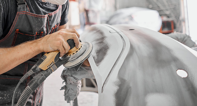 person buffing a car