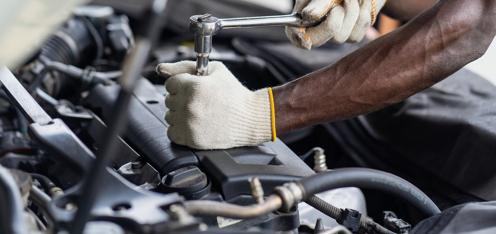 Technician working on car engine